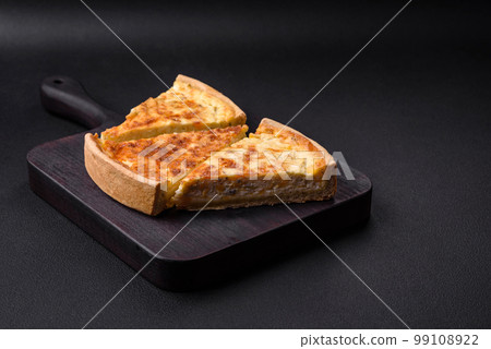 Beautiful delicious quiche pie with four types of cheese with spices and herbs 99108922