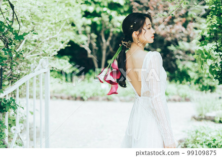 Woman in wedding dress with bouquet of colors 99109875