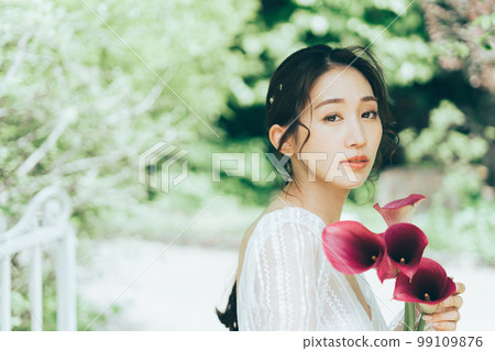 Woman in wedding dress with bouquet of colors 99109876