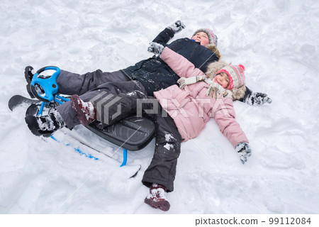 Children play outdoors in winter. Winter vacation 99112084