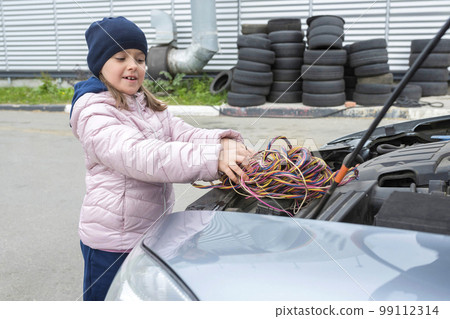 Children's, auto mechanic works in the garage. Outdoor repair services Children's, auto mechanic works in the garage. Outdoor repair services 99112314