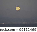 Full moon in the morning just before setting over the mountains 99112469