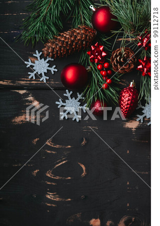 Christmass background red christmas tree toys,silver snowflake and spruce brance on wooden background. Christmass background red christmas tree toys,silver snowflake and spruce brance on wooden background. 99112718