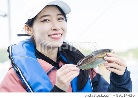 Cute woman enjoying fishing Cute woman enjoying fishing 99114420