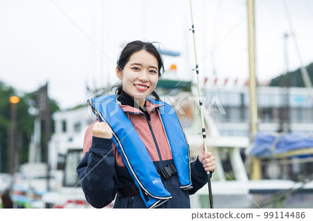 Cute woman enjoying fishing Cute woman enjoying fishing 99114486