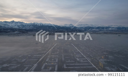 Dawn over the city in fog and smog. Mountain view Dawn over the city in fog and smog. Mountain view 99115111