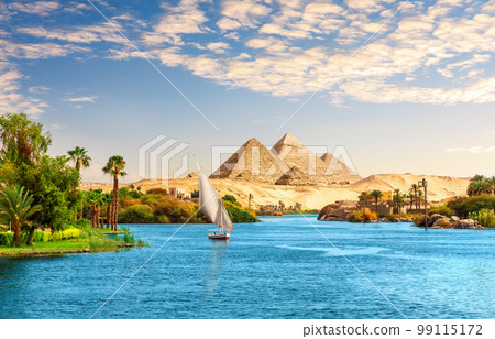 Beautiful Nile scenery with sailboat in the Nile on the way to pyramids, Aswan, Egypt Beautiful Nile scenery with sailboat in the Nile on the way to pyramids, Aswan, Egypt 99115172