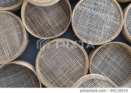 Few Vintage retro sieves for sifting flour and cereals. Background from kitchenware. Set of sieves of various sizes. Few Vintage retro sieves for sifting flour and cereals. Background from kitchenware. Set of sieves of various sizes. 99116014