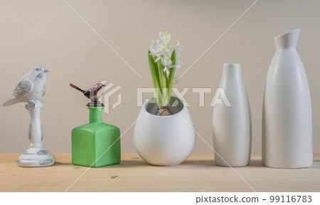 Spring Scandinavian cozy home decor: white vases, white hyacinth and bird figurines 99116783