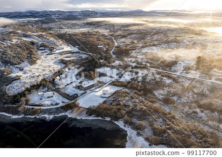 Aerial view of snow covered Lake House by Portnoo in County Donegal, Ireland. 99117700