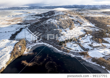 Aerial view of snow covered Cashelgoland by Portnoo in County Donegal, Ireland. 99117701
