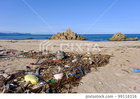 Marine debris washed ashore on a beautiful crystal beach Marine debris washed ashore on a beautiful crystal beach 99118316