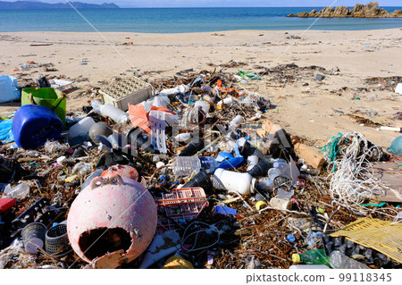 Marine debris washed ashore on a beautiful crystal beach 99118345