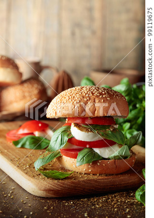 Sandwich with mozzarella, tomatoes, and basil. 99119675