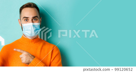Real estate and coronavirus pandemic concept. Close-up of adult man in medical mask pointing at small paper house, standing over light blue background Real estate and coronavirus pandemic concept. Close-up of adult man in medical mask pointing at small paper house, standing over light blue background 99120652