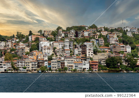 Green mountains of the European side of Bosphorus strait, with traditional houses and dense trees before sunset Green mountains of the European side of Bosphorus strait, with traditional houses and dense trees before sunset 99122364