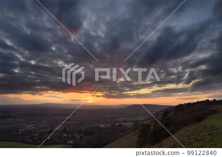 Serene sunset view from Colley Hill between Reigate and Dorking in Surrey, UK. Surrey Hills area of Outstanding Natural Beauty on the North Downs. Looking towards Leith Hill on the Greensand Ridge. 99122840