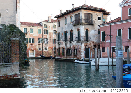 Colorful houses near water in the old medieval street in Venice, Italy. Street scene 99122863