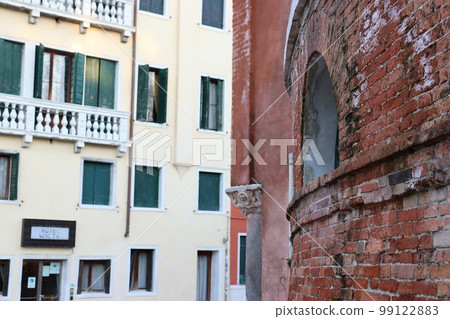 View of the Fondamenta del Monastero in Venice, Italy. Street scene, windows and balcony, old wall. 99122883
