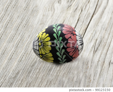 Colorful Easter egg on wooden background. Easter greeting, postcard, copy space. Banner, cover, mockup, for your design Colorful Easter egg on wooden background. Easter greeting, postcard, copy space. Banner, cover, mockup, for your design 99123150