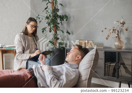 female psychologist conducts psychotherapy session for man female psychologist conducts psychotherapy session for man 99123234