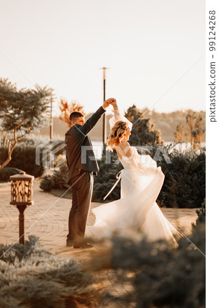 dancing happy bride and groom in nature. at sunset dancing happy bride and groom in nature. at sunset 99124268