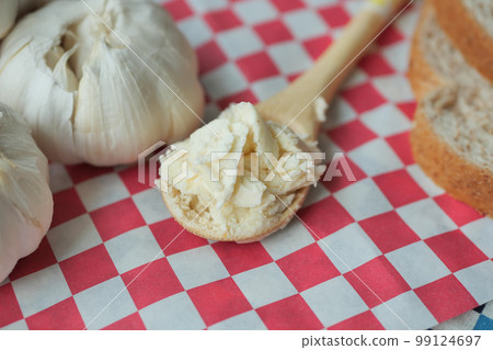 top view of garlic spread on a spoon top view of garlic spread on a spoon 99124697