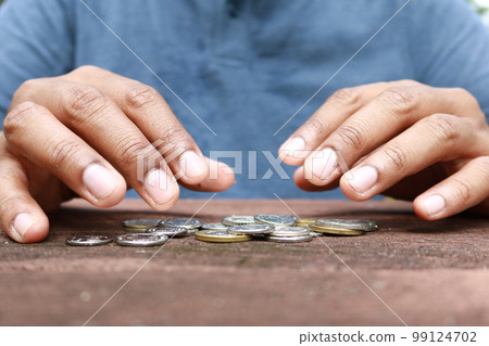 Close up of man hand counting coins Close up of man hand counting coins 99124702