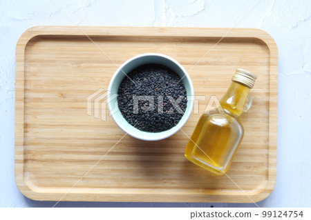 Black Cumin seeds oil on table top view Black Cumin seeds oil on table top view 99124754