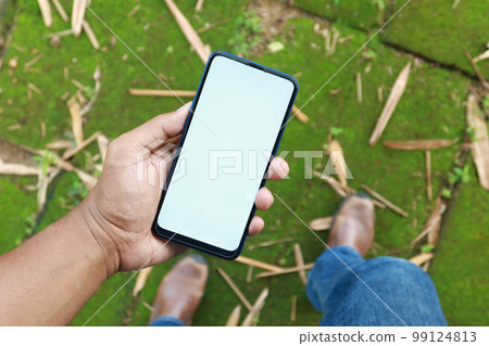 POV shot of young man using smart phone at outdoor POV shot of young man using smart phone at outdoor 99124813