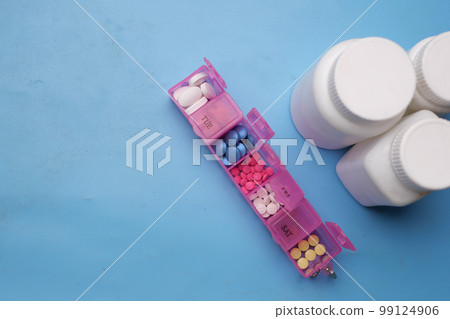 close up of medical pills in a pill box on table  99124906
