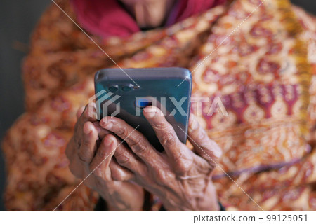 senior women hand using smart phone close up  99125051
