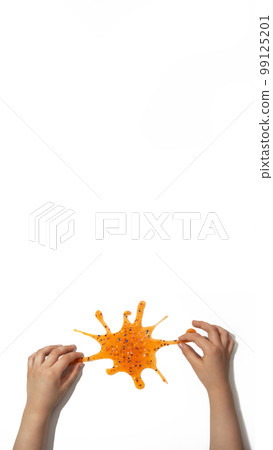 banner orange slime with sequins in child's hands on white background banner orange slime with sequins in child's hands on white background 99125201