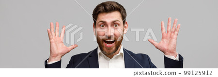 Emotional male business coach in suit puts his hands up and screams 99125912