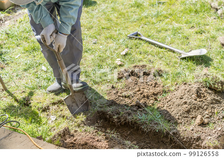 Digging trenches with a shovel Plumbing work Digging trenches with a shovel Plumbing work 99126558
