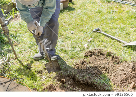 Digging trenches with a shovel Plumbing work Digging trenches with a shovel Plumbing work 99126560