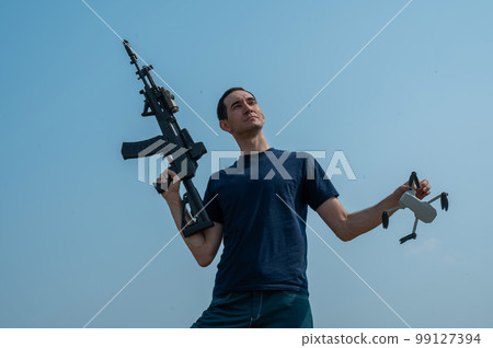 Caucasian man shot down a drone with a shot from a rifle.  99127394