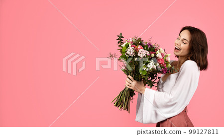 Happy inspired surprised young european woman enjoy bouquet of white tulips, rejoice spring holiday Happy inspired surprised young european woman enjoy bouquet of white tulips, rejoice spring holiday 99127811