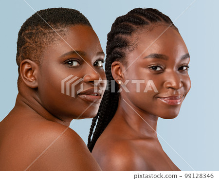 Half-naked young black women posing on studio... - Stock Photo