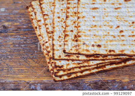 Passover matzoh jewish holiday bread over wooden table. 99129097