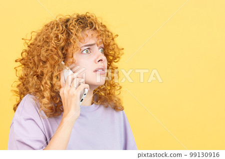Frightened woman talk to the mobile phone Frightened woman talk to the mobile phone 99130916