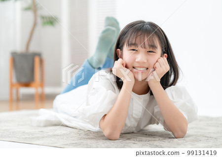 A girl lying down with a cane 99131419