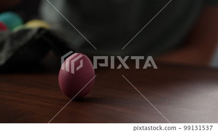 spinning easter egg on walnut table 99131537