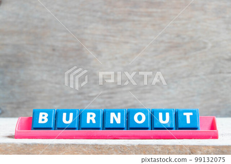 Tile alphabet letter with word burnout in red color rack on wood background Tile alphabet letter with word burnout in red color rack on wood background 99132075