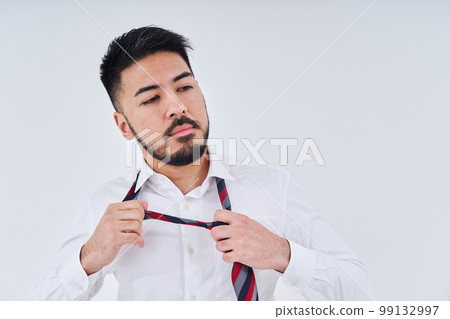 A businessman preparing a tie 99132997