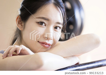 Young woman taking a break at the gym 99133213