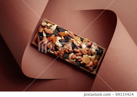 The mix of dried fruits and berries on a brown background. 99133424