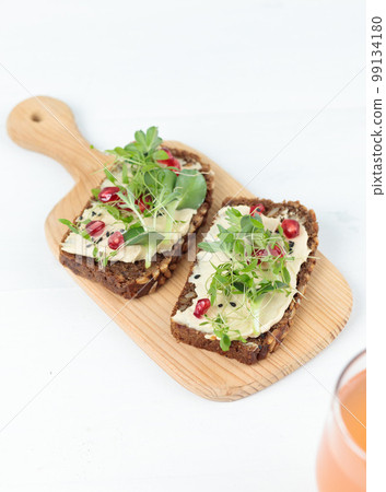 A healthy snack. Lunch. Sandwiches with hummus and micro-greenery. Close-up. A healthy snack. Lunch. Sandwiches with hummus and micro-greenery. Close-up. 99134180