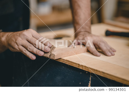 Professional Carpenter Joiner hand use sand paper making furniture. home builder diy projects authentic Handcraft Wood worker. 99134301