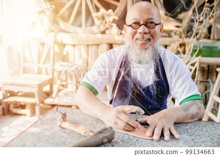 portrait happy leather maker artist handcraft working at own workshop small studio made by order masterwork piece portrait happy leather maker artist handcraft working at own workshop small studio made by order masterwork piece 99134663